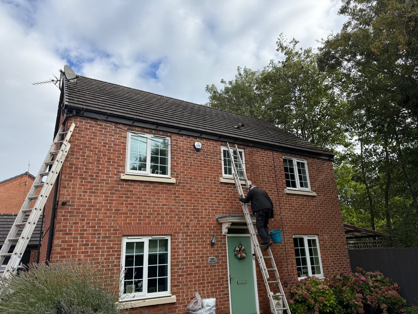 Guttering work in progress at a two-storey red-brick house