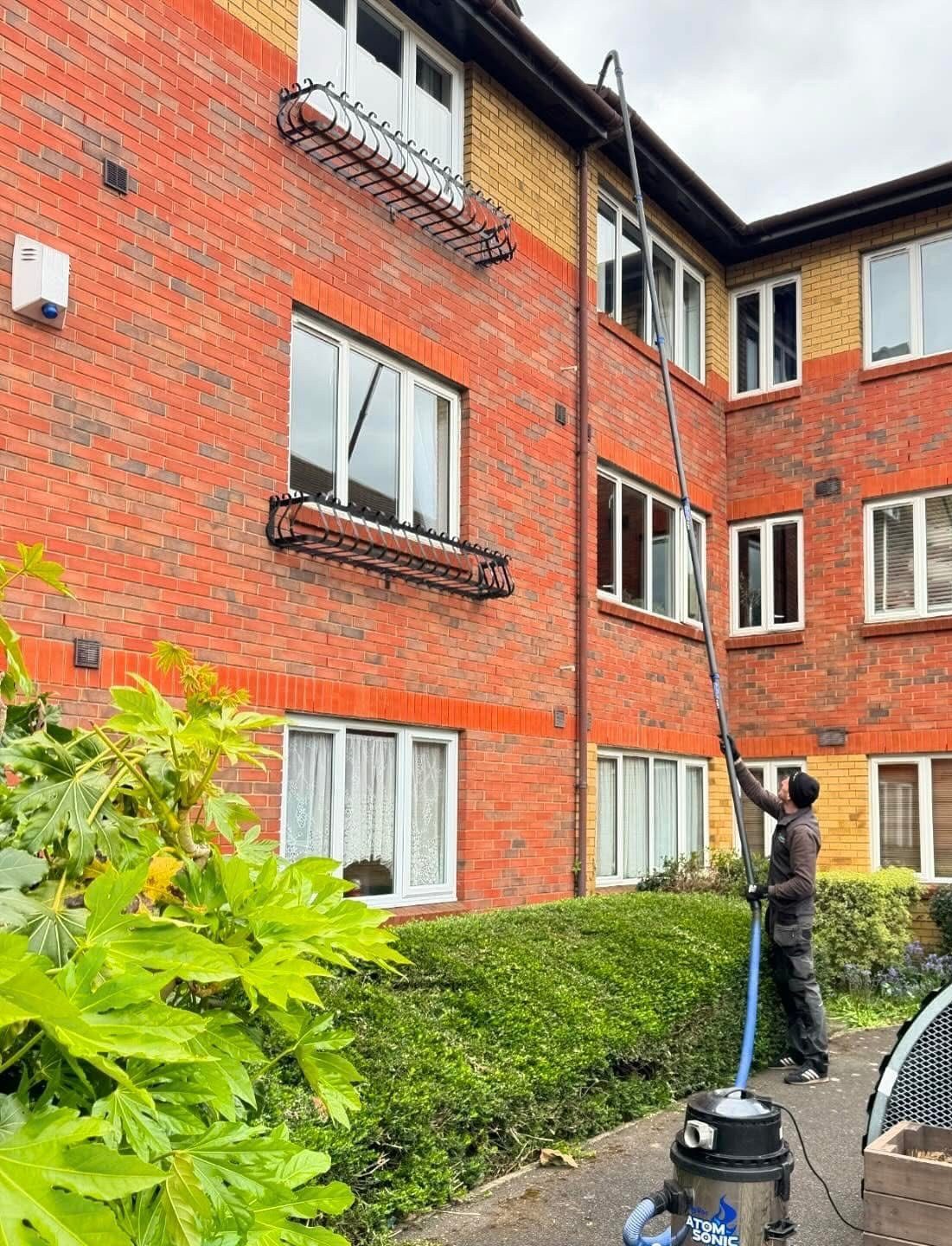 Cleaning gutters from the ground with a high-reach pole system